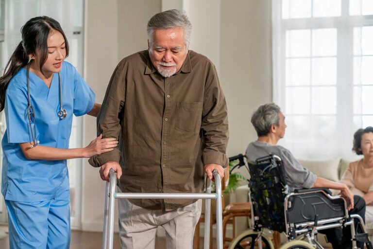 Family member reviews a care plan with an assisted living resident at a quiet table.